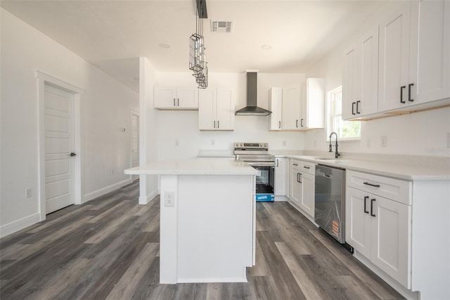 5670 NE 140th Ct, Williston, FL 32696 - kitchen with appliances with stainless steel finishes, wall chimney range hood, a sink, white cabinets, and dark wood-style flooring