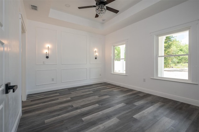 5670 NE 140th Ct, Williston, FL 32696 - unfurnished room with dark wood-style floors, a ceiling fan, a tray ceiling, and baseboards