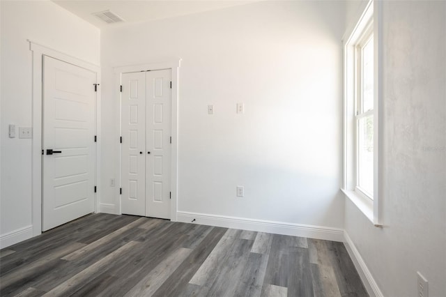 5670 NE 140th Ct, Williston, FL 32696 - unfurnished bedroom with wood finished floors, a closet, and baseboards