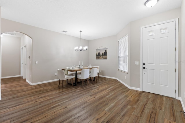 1044 SW 159th St, Ocala, FL 34473 - dining area featuring arched walkways, wood finished floors, and baseboards