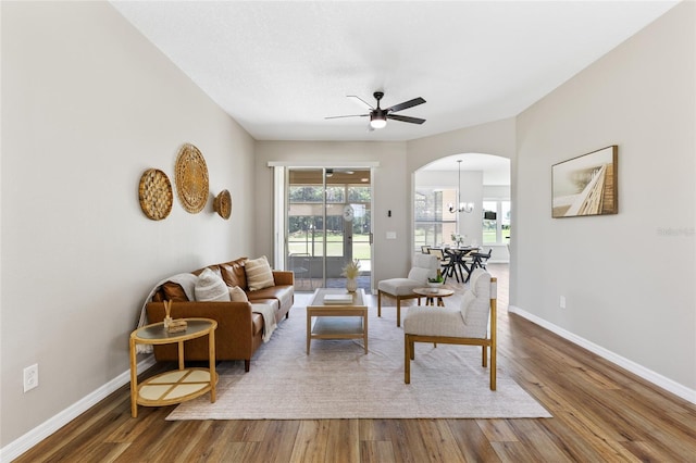 1044 SW 159th St, Ocala, FL 34473 - living room featuring ceiling fan, wood finished floors, baseboards, and arched walkways