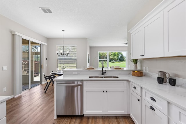 1044 SW 159th St, Ocala, FL 34473 - kitchen featuring stainless steel dishwasher, a sink, a peninsula, white cabinetry, and light wood-style flooring