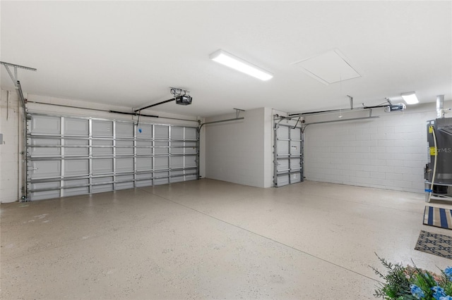 1044 SW 159th St, Ocala, FL 34473 - garage with a garage door opener, concrete block wall, and gas water heater
