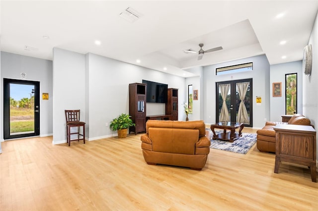 5479 S Biscayne Dr, North Port, FL 34287 - living room featuring light wood-type flooring, recessed lighting, baseboards, ceiling fan, and a tray ceiling
