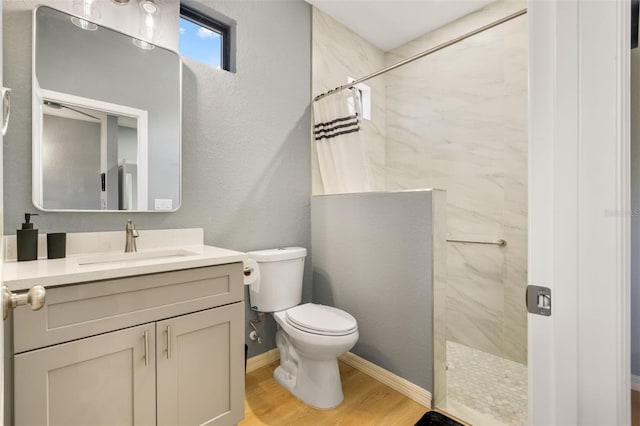 5479 S Biscayne Dr, North Port, FL 34287 - bathroom featuring tiled shower, wood finished floors, vanity, toilet, and baseboards