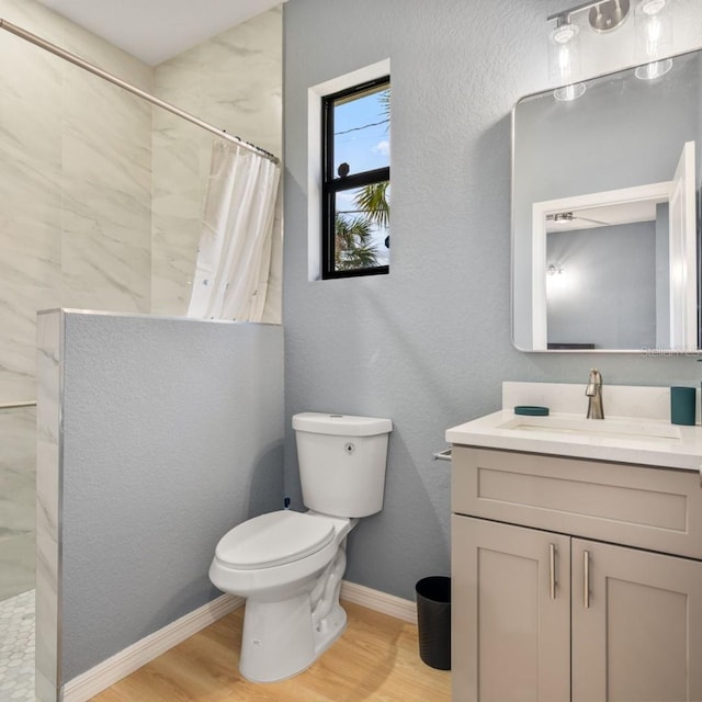 5479 S Biscayne Dr, North Port, FL 34287 - bathroom with wood finished floors, vanity, tiled shower, toilet, and baseboards