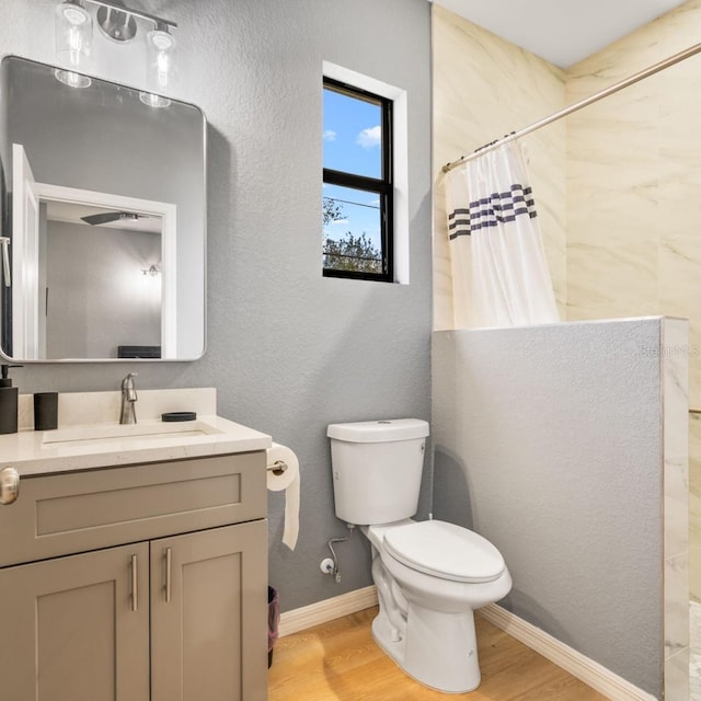 5479 S Biscayne Dr, North Port, FL 34287 - full bath featuring a tile shower, vanity, toilet, wood finished floors, and a textured wall