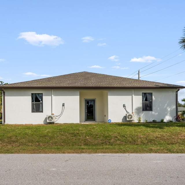 5479 S Biscayne Dr, North Port, FL 34287 - back of property featuring a cooling unit, stucco siding, and a yard