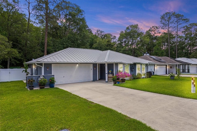 3729 NW 47th Ter, Gainesville, FL 32606 - ranch-style house with a garage, driveway, a standing seam roof, and metal roof
