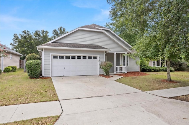 7909 SW 87th Ter, Gainesville, FL 32608 - view of front facade with a front yard, concrete driveway, an attached garage, a porch, and roof with shingles