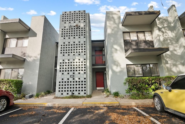 401 NW 39th Rd Unit 401C, Gainesville, FL 32607 - view of front of property featuring uncovered parking and stucco siding