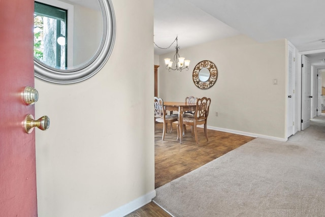 401 NW 39th Rd Unit 401C, Gainesville, FL 32607 - carpeted entrance foyer featuring baseboards and a chandelier