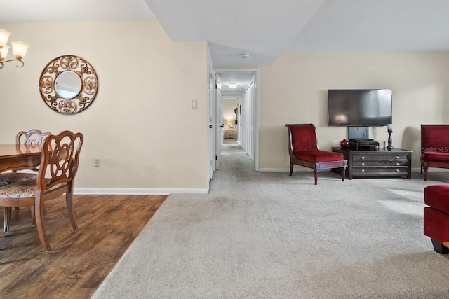 401 NW 39th Rd Unit 401C, Gainesville, FL 32607 - living room featuring baseboards, a chandelier, and carpet floors