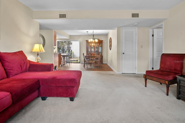 401 NW 39th Rd Unit 401C, Gainesville, FL 32607 - living room with carpet flooring, a chandelier, and baseboards