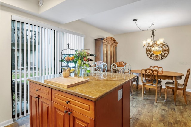 401 NW 39th Rd Unit 401C, Gainesville, FL 32607 - kitchen featuring healthy amount of natural light, wood finished floors, a chandelier, and baseboards