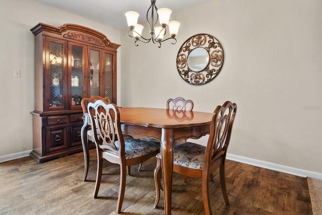 401 NW 39th Rd Unit 401C, Gainesville, FL 32607 - dining room with a chandelier, wood finished floors, and baseboards