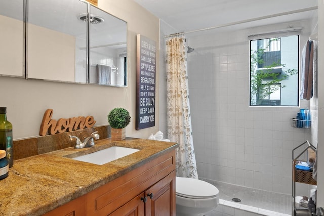 401 NW 39th Rd Unit 401C, Gainesville, FL 32607 - bathroom with a tile shower, toilet, and vanity