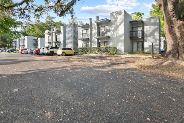 401 NW 39th Rd Unit 401C, Gainesville, FL 32607 - view of front of property with uncovered parking and a balcony