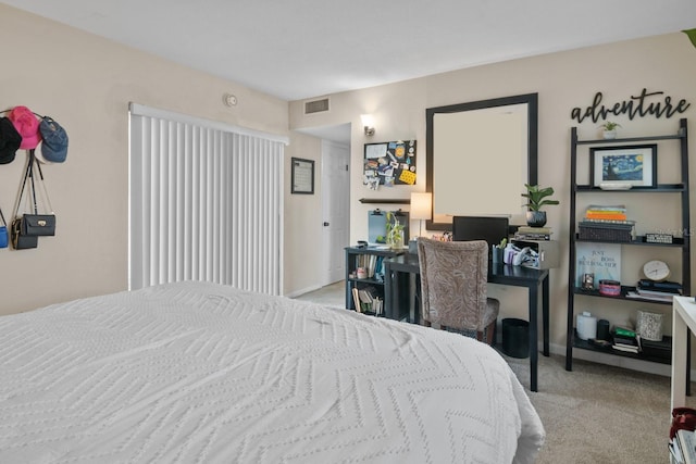 401 NW 39th Rd Unit 401C, Gainesville, FL 32607 - bedroom with a desk, light carpet, and baseboards