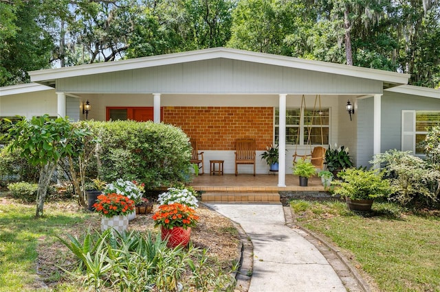 2035 NW 12th Rd, Gainesville, FL 32605 - view of front of property featuring a porch and brick siding