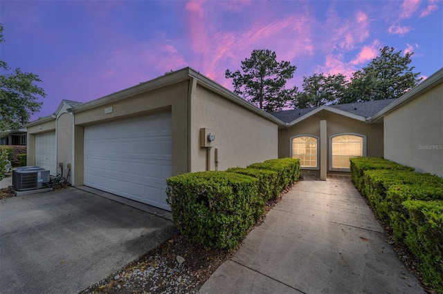 6245 NW 106th Pl Unit 6245, Alachua, FL 32615 - view of front of house with central AC unit, stucco siding, and a garage