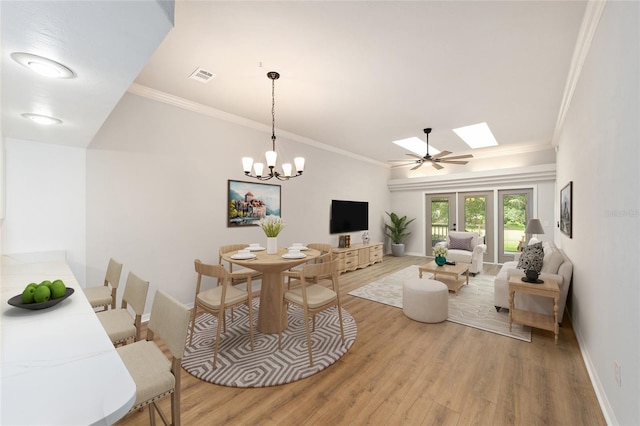 6245 NW 106th Pl Unit 6245, Alachua, FL 32615 - dining area with light wood-type flooring, baseboards, a skylight, ornamental molding, and a chandelier