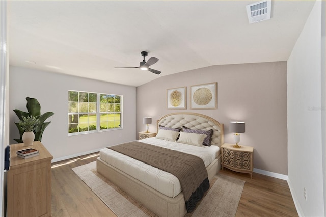 6245 NW 106th Pl Unit 6245, Alachua, FL 32615 - bedroom with vaulted ceiling, baseboards, wood finished floors, and a ceiling fan