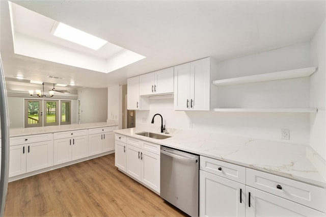 6245 NW 106th Pl Unit 6245, Alachua, FL 32615 - kitchen with open shelves, stainless steel dishwasher, a sink, and white cabinets