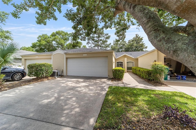 6245 NW 106th Pl Unit 6245, Alachua, FL 32615 - view of front of home featuring stucco siding, an attached garage, central AC, and concrete driveway