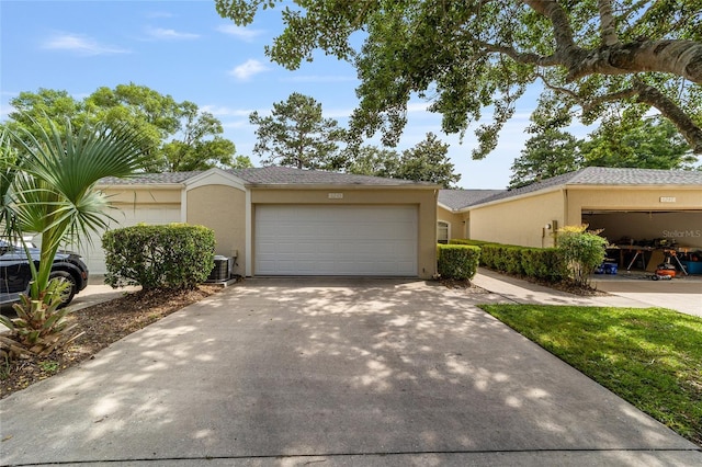 6245 NW 106th Pl Unit 6245, Alachua, FL 32615 - view of front of house featuring stucco siding, a garage, concrete driveway, and cooling unit