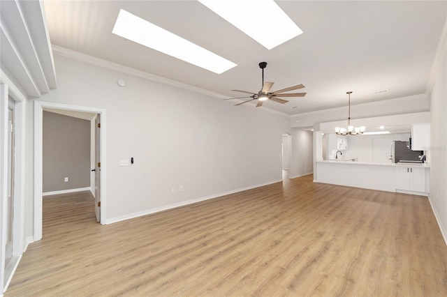 6245 NW 106th Pl Unit 6245, Alachua, FL 32615 - unfurnished living room featuring a skylight, light wood-style flooring, a chandelier, ornamental molding, and baseboards