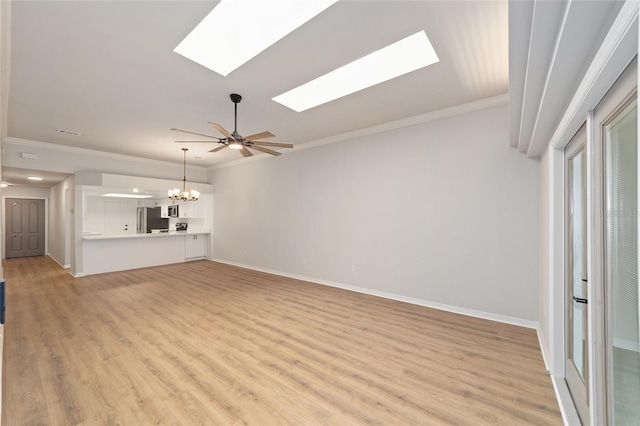 6245 NW 106th Pl Unit 6245, Alachua, FL 32615 - unfurnished living room with a skylight, a chandelier, light wood-style flooring, ornamental molding, and baseboards