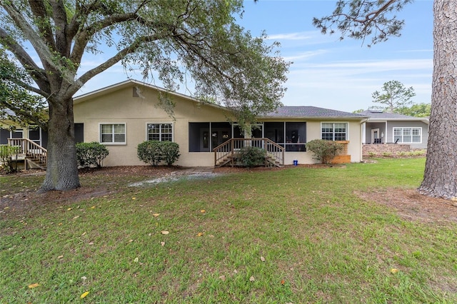 6245 NW 106th Pl Unit 6245, Alachua, FL 32615 - back of house with a sunroom, stucco siding, a yard, and stairway