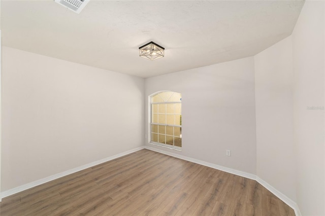 6245 NW 106th Pl Unit 6245, Alachua, FL 32615 - empty room featuring wood finished floors and baseboards