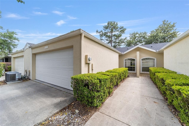 6245 NW 106th Pl Unit 6245, Alachua, FL 32615 - view of front of property featuring central AC unit, a garage, and stucco siding