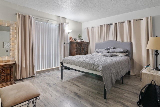 2811 SW Archer Rd Unit O123, Gainesville, FL 32608 - bedroom with a textured ceiling and wood finished floors