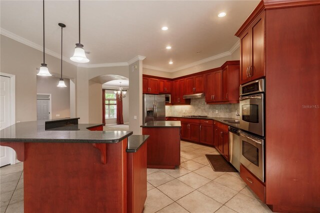 5119 NW 57th St, Gainesville, FL 32653 - kitchen featuring stainless steel appliances, a kitchen island, reddish brown cabinets, light tile patterned floors, and crown molding