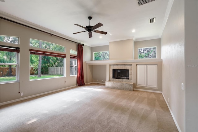 5119 NW 57th St, Gainesville, FL 32653 - unfurnished living room with crown molding, ceiling fan, carpet flooring, baseboards, and a fireplace