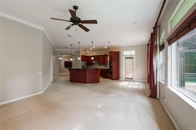 5119 NW 57th St, Gainesville, FL 32653 - kitchen with reddish brown cabinets, decorative backsplash, open floor plan, baseboards, and appliances with stainless steel finishes