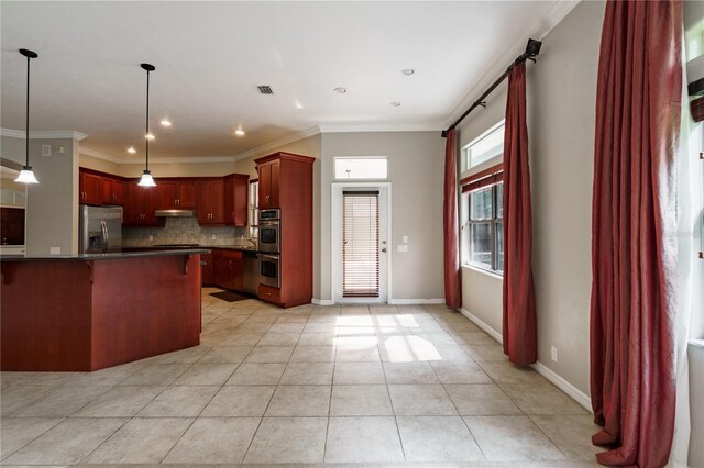 5119 NW 57th St, Gainesville, FL 32653 - kitchen with appliances with stainless steel finishes, reddish brown cabinets, dark countertops, tasteful backsplash, and a kitchen bar