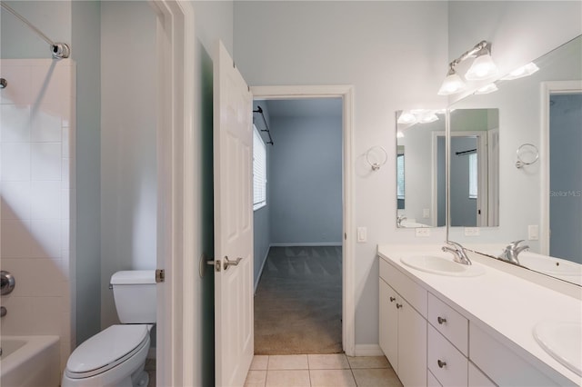 5119 NW 57th St, Gainesville, FL 32653 - bathroom featuring double vanity, toilet, tile patterned flooring,  shower combination, and baseboards