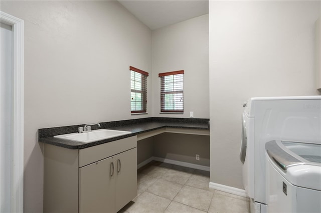 5119 NW 57th St, Gainesville, FL 32653 - laundry area featuring a sink, light tile patterned flooring, separate washer and dryer, and baseboards