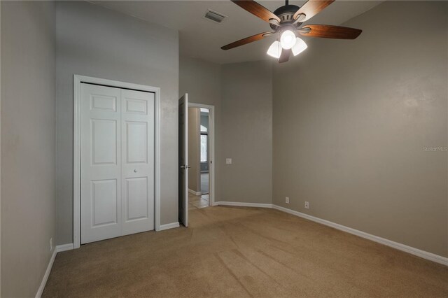 5119 NW 57th St, Gainesville, FL 32653 - unfurnished bedroom with light colored carpet, baseboards, a closet, and a ceiling fan