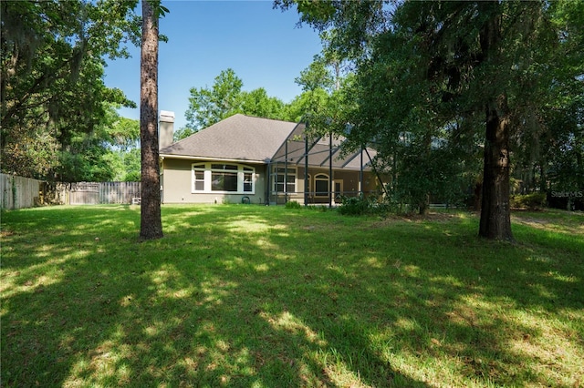 5119 NW 57th St, Gainesville, FL 32653 - rear view of house with glass enclosure and a chimney