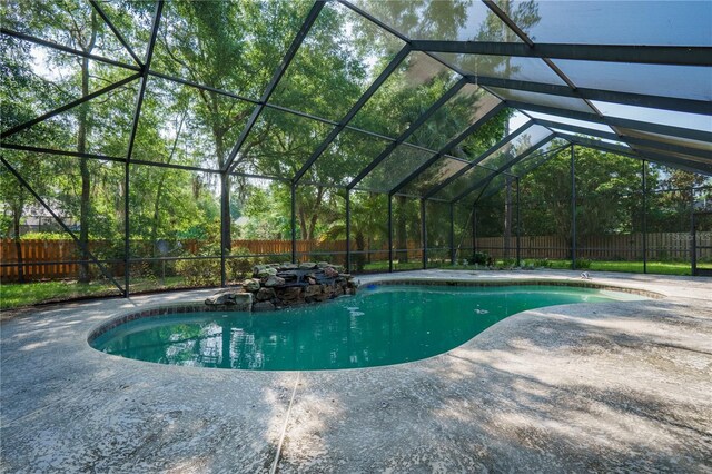 5119 NW 57th St, Gainesville, FL 32653 - view of swimming pool with a fenced backyard, a patio, and glass enclosure