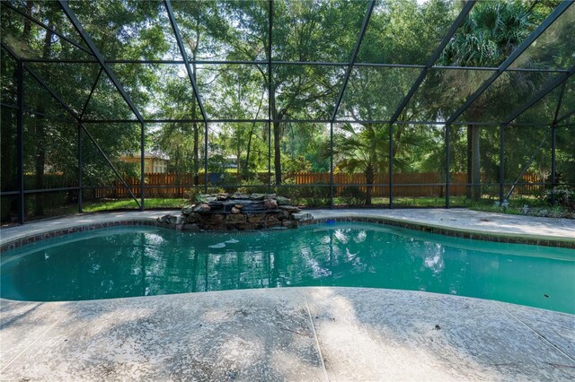 5119 NW 57th St, Gainesville, FL 32653 - view of swimming pool featuring a fenced backyard, glass enclosure, and a patio
