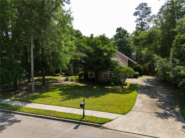 5119 NW 57th St, Gainesville, FL 32653 - obstructed view of property featuring driveway and a front lawn