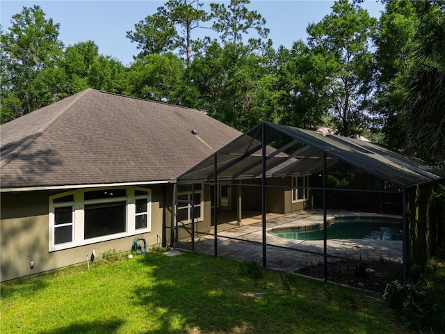 5119 NW 57th St, Gainesville, FL 32653 - rear view of property featuring a patio area, roof with shingles, a yard, an outdoor pool, and stucco siding
