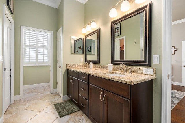 2898 SW 117th Way, Gainesville, FL 32608 - bathroom with double vanity, crown molding, and baseboards