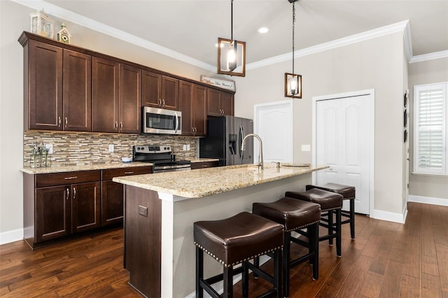 2898 SW 117th Way, Gainesville, FL 32608 - kitchen featuring stainless steel appliances, backsplash, dark wood-type flooring, dark brown cabinetry, and ornamental molding